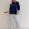 Peruzzi Stripe Trouser Navy featuring a fresh navy and white vertical stripe with a flattering cropped, wide-leg silhouette and statement turn-up cuffs.