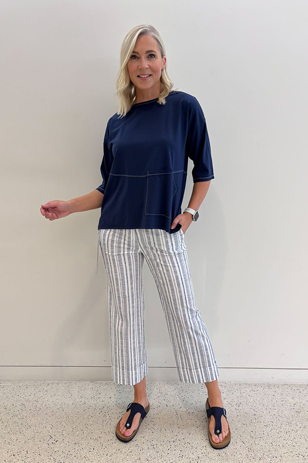 Peruzzi Stripe Trouser Navy featuring a fresh navy and white vertical stripe with a flattering cropped, wide-leg silhouette and statement turn-up cuffs.