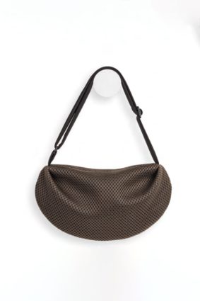 The In.Zu Bean Bag Brown Dots BND features a relaxed crescent shape, textured dot design and adjustable shoulder strap.