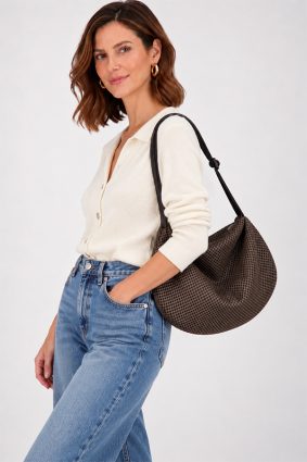 The In.Zu Bean Bag Brown Dots BND features a relaxed crescent shape, textured dot design and adjustable shoulder strap.
