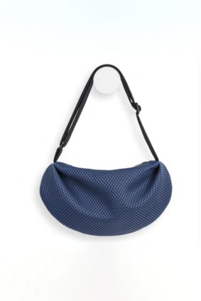 The In.Zu Bean Bag Riverside Dots features a relaxed crescent shape, textured dot design and adjustable shoulder strap.
