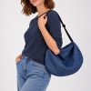 The In.Zu Bean Bag Riverside Dots features a relaxed crescent shape, textured dot design and adjustable shoulder strap.