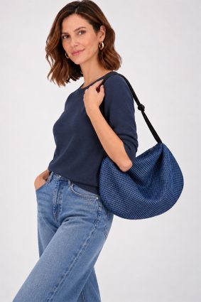 The In.Zu Bean Bag Riverside Dots features a relaxed crescent shape, textured dot design and adjustable shoulder strap.