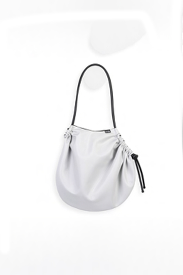 The In.Zu Cocconeo Bag Off White Latex Owl features a soft, rounded silhouette with elegant gathered detailing, adjustable black drawstrings and a sleek shoulder strap.