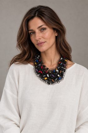 The Neo Long Mesh N Multicolour is a distinctive statement necklace featuring intricate black mesh interwoven with vibrant multicoloured accents.
