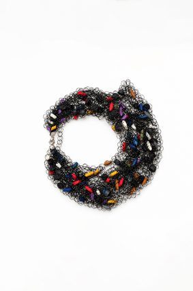 The Neo Long Mesh N Multicolour is a distinctive statement necklace featuring intricate black mesh interwoven with vibrant multicoloured accents.